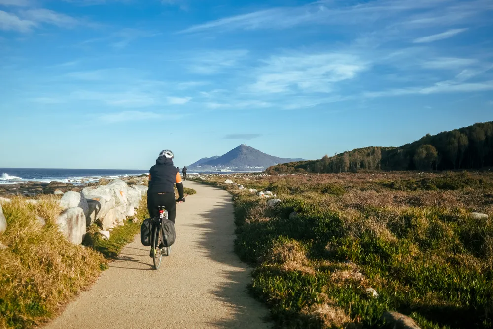 Ciclista num trilho junto à costa do Minho, no Caminho da Costa · Táxi Afonso Caminha 06